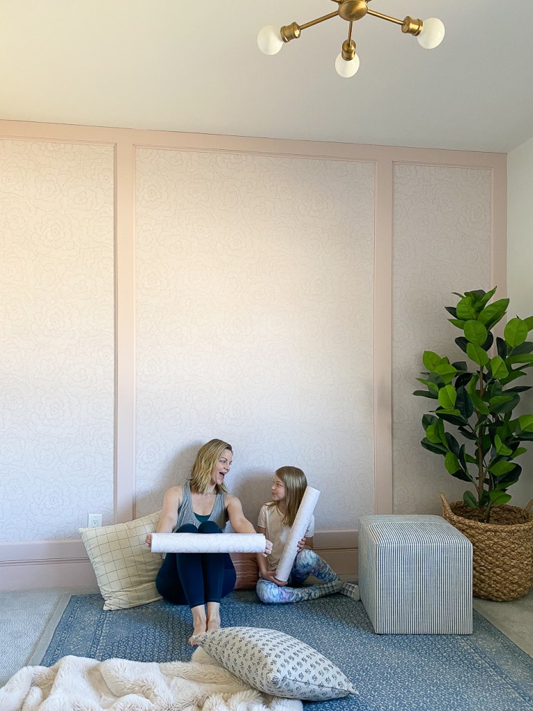 Wallpaper feature wall being carefully installed